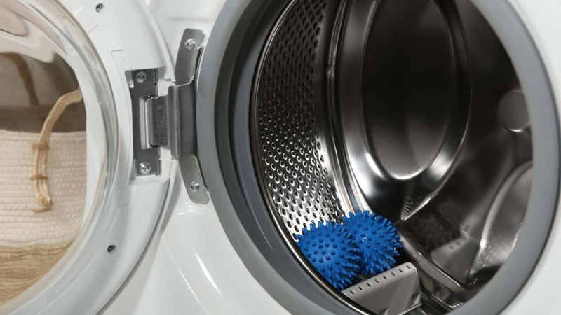 Two plastic dryer balls in the dryer—Wool dryer balls vs plastic dryer balls: which are better?